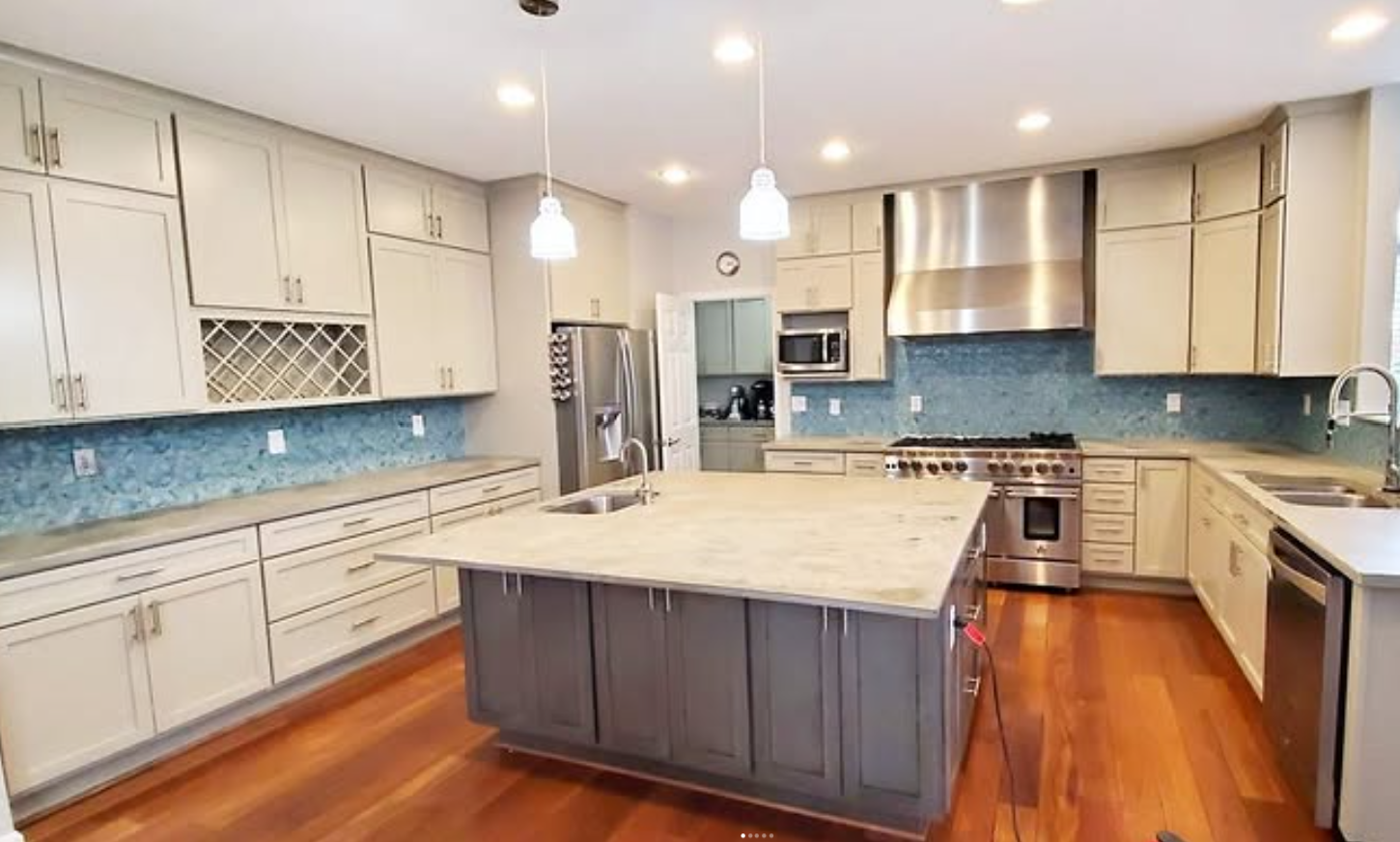 Kitchen remodel with blue glass backsplash by CR General Contracting