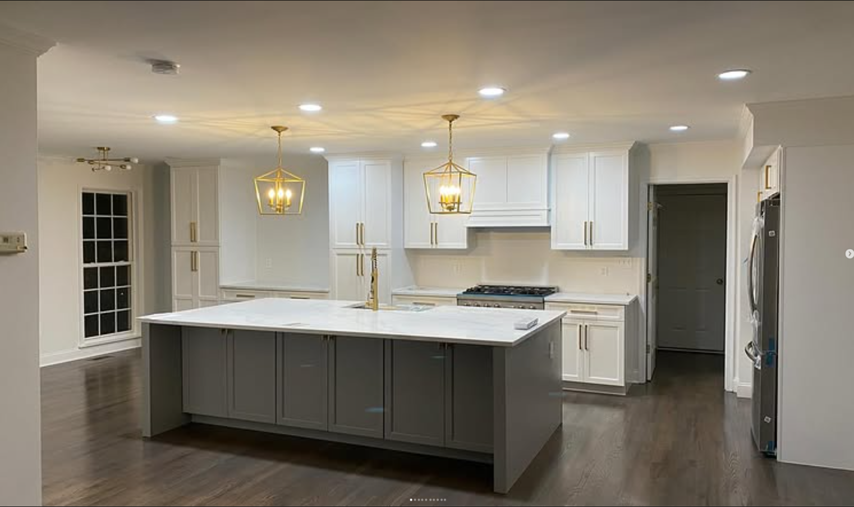 Modern kitchen remodel with gray island and gold fixtures by CR General Contracting